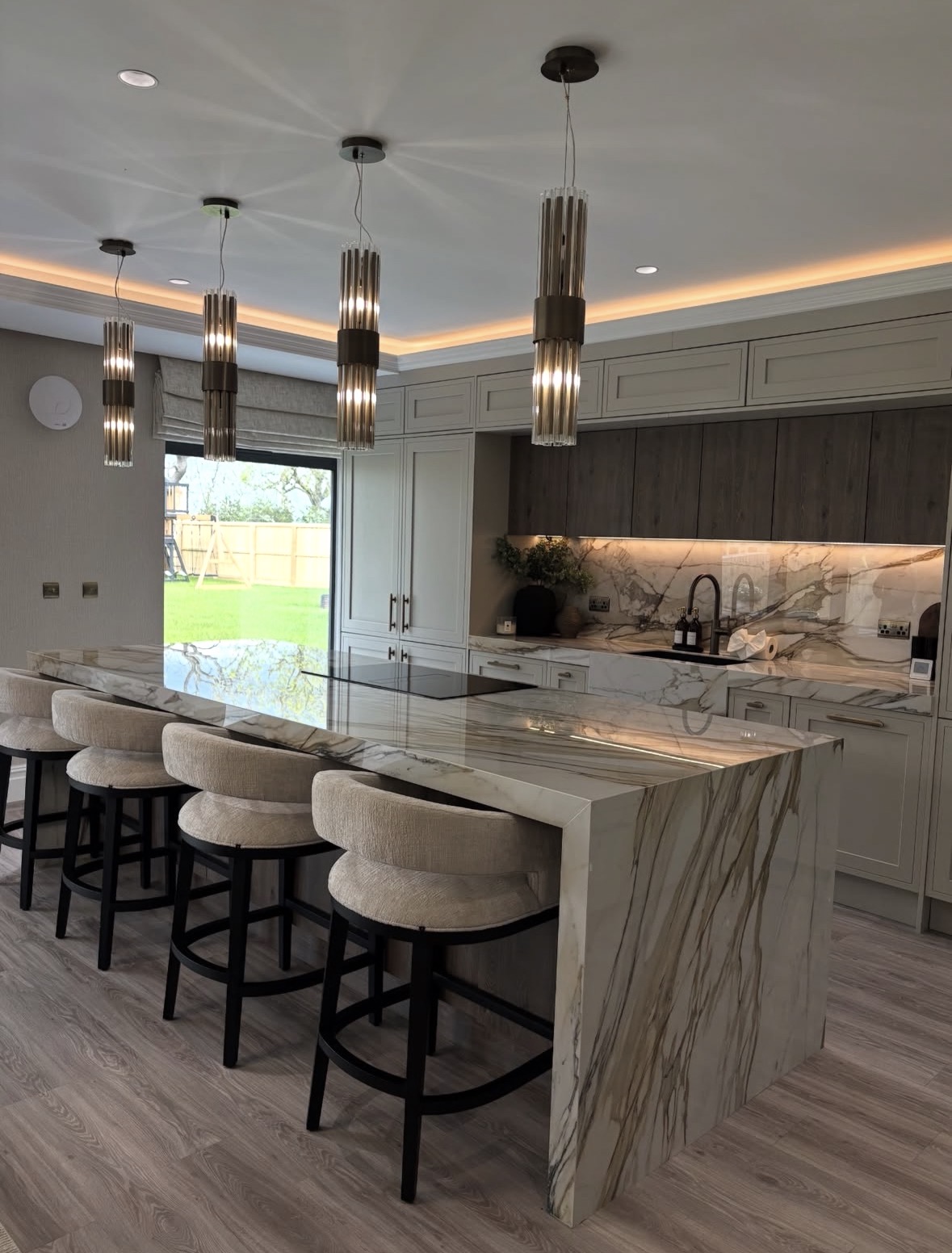 Spotless modern kitchen with marble island cleaned by The Cleaning Guys